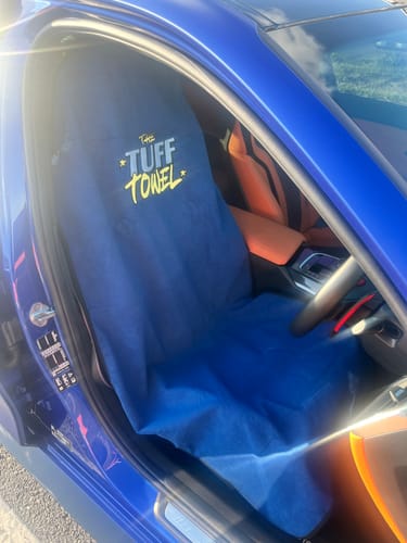 Customer's blue Waterproof Car Towel Seat Cover with 'Tuff Towel' logo fitted on a car seat.
