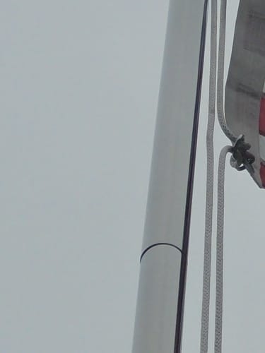 Close-up of the reviewer's stainless steel Flag Snap Hook and new rope on a flagpole.