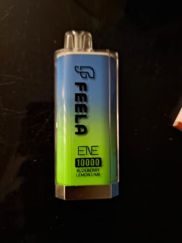 Customer's Elux Feela ENE 10000 disposable vape in a blue and green gradient, shown on a dark surface.