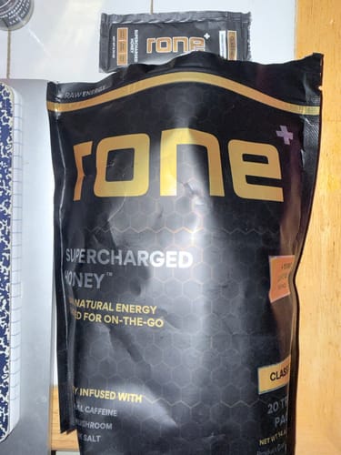 Customer's large 20-pack bag of SuperCharged Honey with a single-serving packet resting on top.