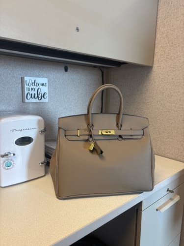 Customer's structured beige Warkin Bag sitting on an office desk, showing its shape and hardware.