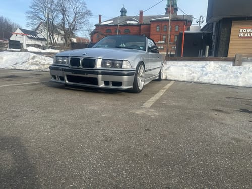 Reviewer's silver BMW parked, showing the wider wheel stance from the installed wheel spacers.