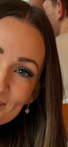 Close-up of a reviewer's eye showing long, full lashes applied with the Infinaluxe Lash Bond.