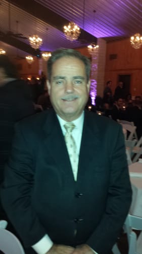 Reviewer for Colagene supplement smiling while standing at an indoor event.