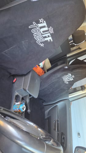 Customer's black Waterproof Car Towel Seat Covers installed on both front seats of a car.