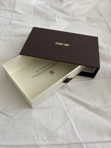 Customer's open and empty Sticky Zoo® box for the ENERGY BEAR CASE on a white sheet.