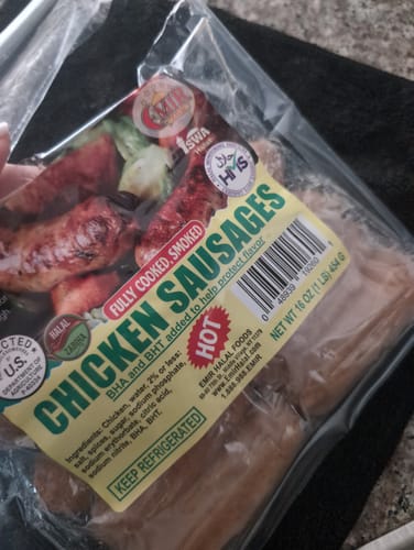 Customer holding a package of the Hot Chicken Halal Breakfast Sausage.