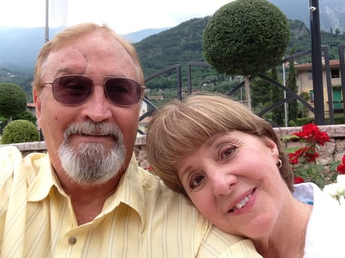 Reviewer, a smiling older man, posing with a companion outdoors.