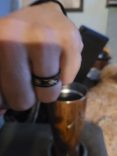A customer's hand wearing the hammered black Titanfall ring.