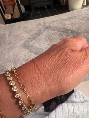 Reviewer shows a close-up of the Classic Bezel Tennis Bracelet on their wrist.