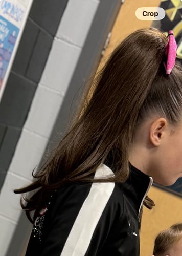 Reviewer showing the Stranded Blowout Clip-in Ponytail creating a full, high brown ponytail.