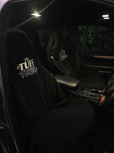Customer's two black Waterproof Car Towel Seat Covers installed on the driver and passenger seats of a car.