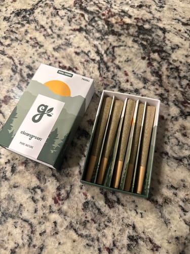 Customer's open box of Royal Cherry Pre-Rolls on a countertop, with the individual pre-rolls lined up inside.