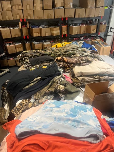 Reviewer's large order of the Hunting Camo Mix piled high on a table for sorting in a stockroom.