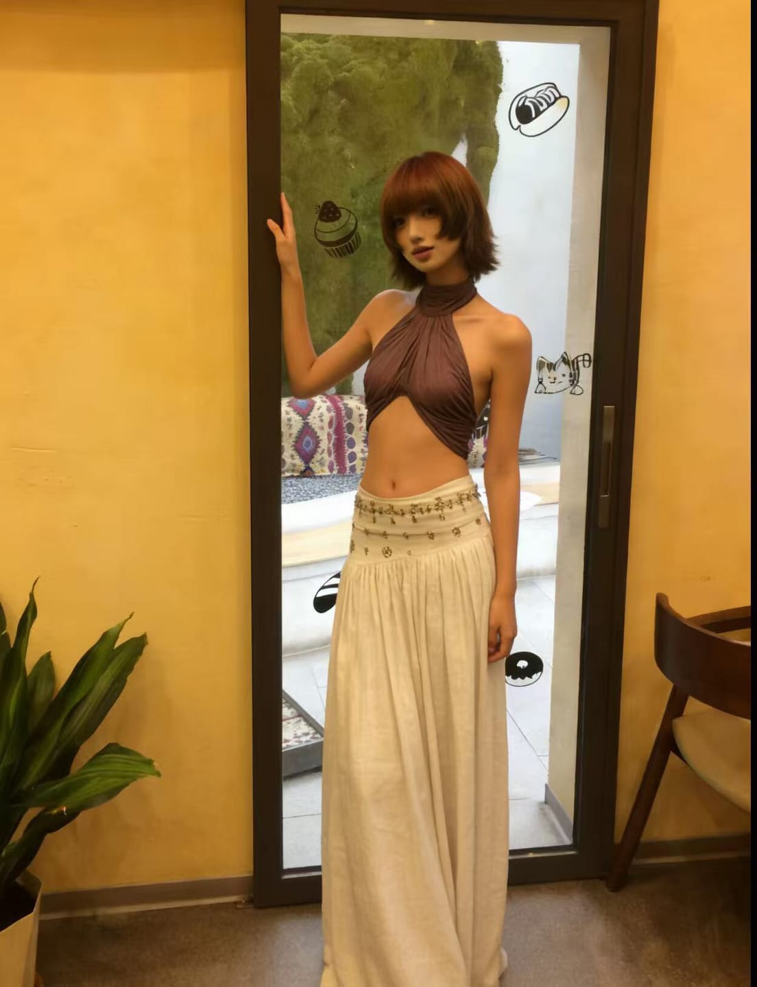 Customer photo review of ROVENTE Cross-Drape Halter Top with High Neck Twist Detail