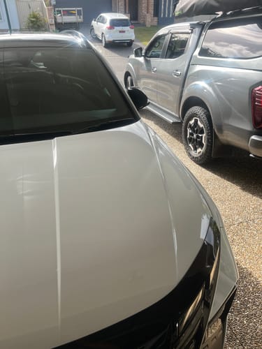 Reviewer's clean white car and silver 4WD after being washed with the Mega Value 4WD Care Package.