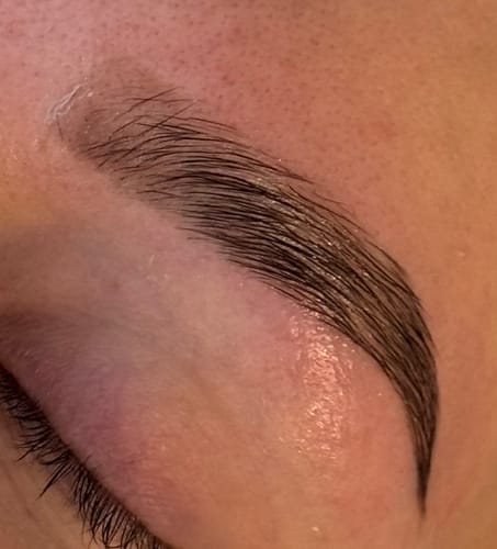 Reviewer's close-up of a defined, dark eyebrow after using the Oak - Hybrid Brow Stain.