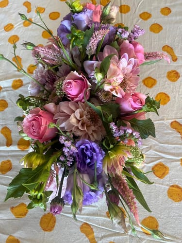 Customer's beautiful floral arrangement from the Cupcake Bloom Box, featuring lush pink and purple flowers.