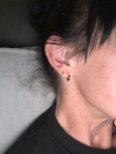 Close-up of a reviewer's ear showing the Onyx Tiny Hoop Earring.