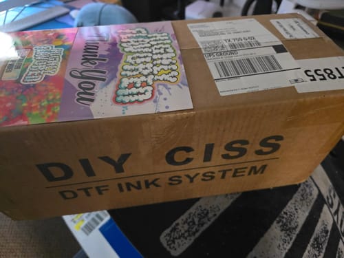 Customer's shipping box for the DTF CISS, labeled 'DIY CISS DTF INK SYSTEM' on the side.