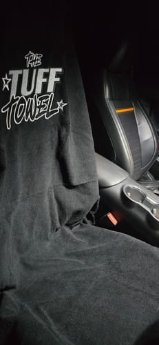 Customer's black Waterproof Car Towel Seat Cover fitted on a performance car seat in a dark interior.