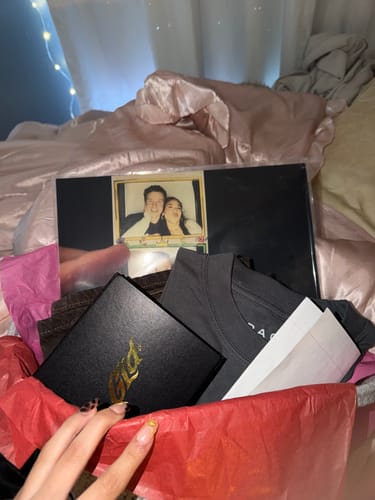 Customer's custom vinyl record with a personalized photo on the sleeve, displayed inside a gift box.