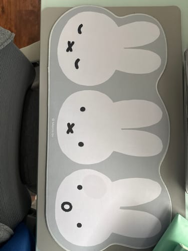 Customer's gray Miffy Large Keyboard Mat laid flat on a desk, showing the three cute bunny faces.