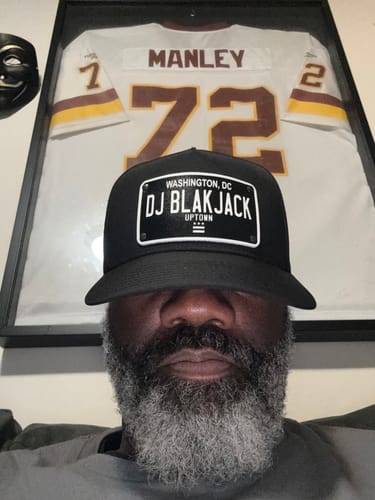 Reviewer wearing the black Washington DC Blackout Plate Hat with 'DJ BLAKJACK' customized on the front patch.