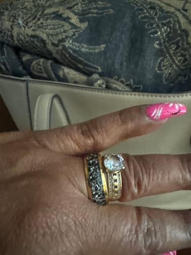 Close-up of a reviewer's hand wearing the Solaris ring with its meteorite inlay next to another ring.