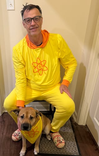 Customer's dog wearing the yellow 'Feel the Power' bandana, matching the owner's bright yellow outfit.