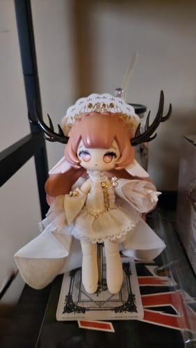 Customer's Rena action figure fully assembled on its stand, wearing a white dress and antlers.