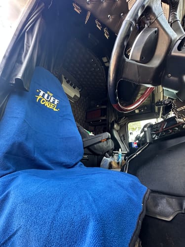 Customer's blue Waterproof Car Towel Seat Cover draped over the driver's seat of a truck.