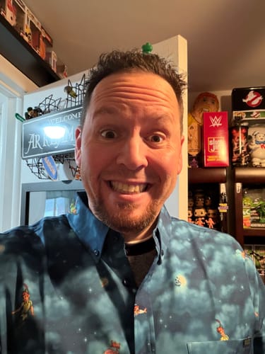 Reviewer smiling excitedly in a selfie while wearing the blue Peter Pan 'You Can Fly!' shirt.