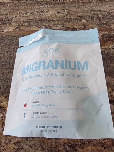 Customer's white pouch of Migranium daily support supplement resting on a countertop.