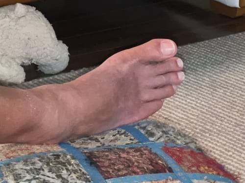 Reviewer's foot showing smooth skin after using the Florida Citrus Luxe Sugar Scrub.