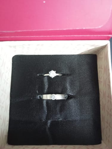 Reviewer's photo of the Anushka Sharma Silver Minimal Couple Rings. The two silver rings with zircons are shown in their open box.