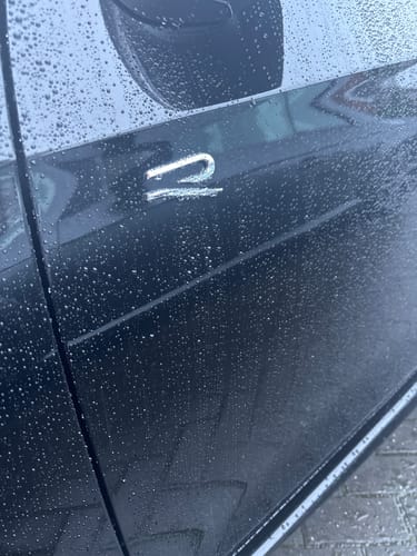 Customer photo showing excellent water beading from the Elixir Polymer Sealant on a black car panel.