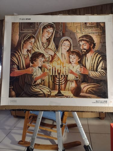 Customer's completed Custom Paint by Numbers Kit showing a detailed painting of a family lighting a menorah.