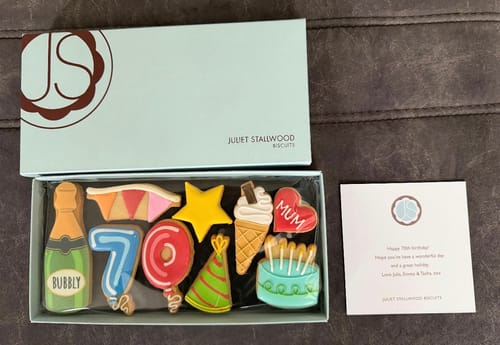 Customer's Birthday Balloon Deluxe Biscuit Box open, showing colorful iced biscuits for a 70th birthday.