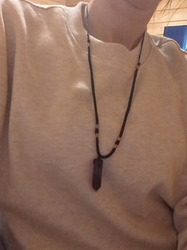 Close-up of a reviewer wearing the dark Natural Fluorite Necklace on a string cord against a sweater.