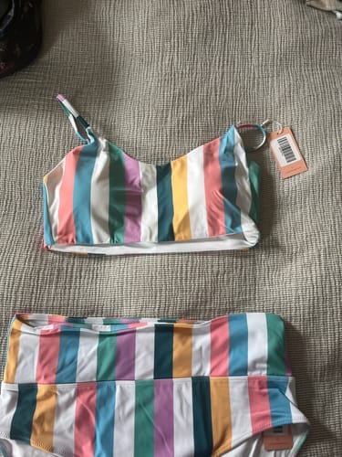 Customer's Sunkissed Bikini Top and matching bottoms in a colorful retro stripe pattern laid out flat.