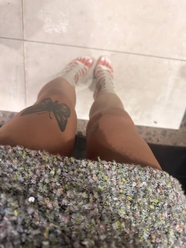 Reviewer's top-down view while wearing the grey Snake Heels, showing the python texture and lace-up design.