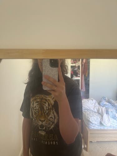 Reviewer taking a mirror selfie to show their stylish Cloud Bloom iPhone Case.