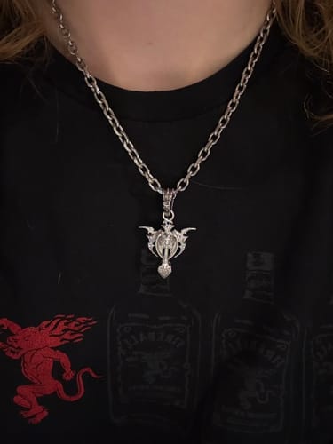 Customer wearing the silver Tribal Cross Pendant on a link chain against a black shirt.