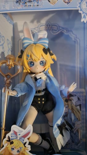 Customer's cute Start Again Series Alice BJD figure with blonde hair and a blue coat, displayed inside its box.