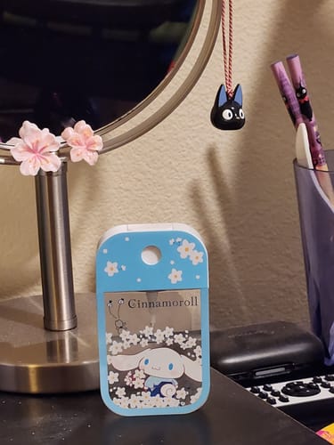 Customer's cute Jiji bell charm from Kiki's Delivery Service hanging on a round mirror.