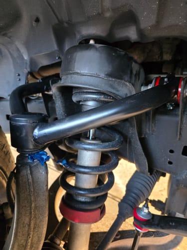 Customer's installed black Upper Control Arms and Sway Bar Links on a lifted Ram 1500, showing corrected suspension.