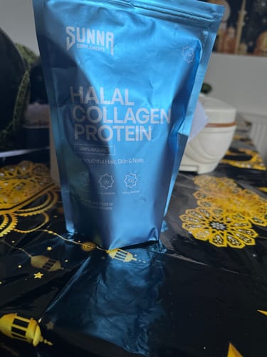 Customer's light blue pouch of Halal Collagen Protein sitting on a decorative black and gold tablecloth.