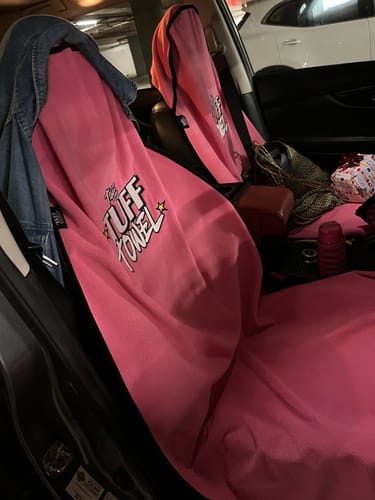 Customer's two pink Tuff Towel seat covers draped over the front seats of a car.