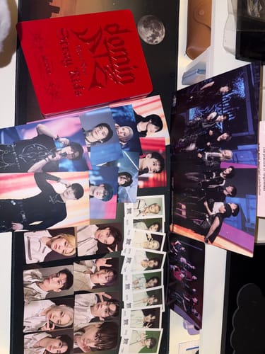 Customer's STRAY KIDS dominATE BLU-RAY set shown with the red case and numerous postcards and polaroids spread out.